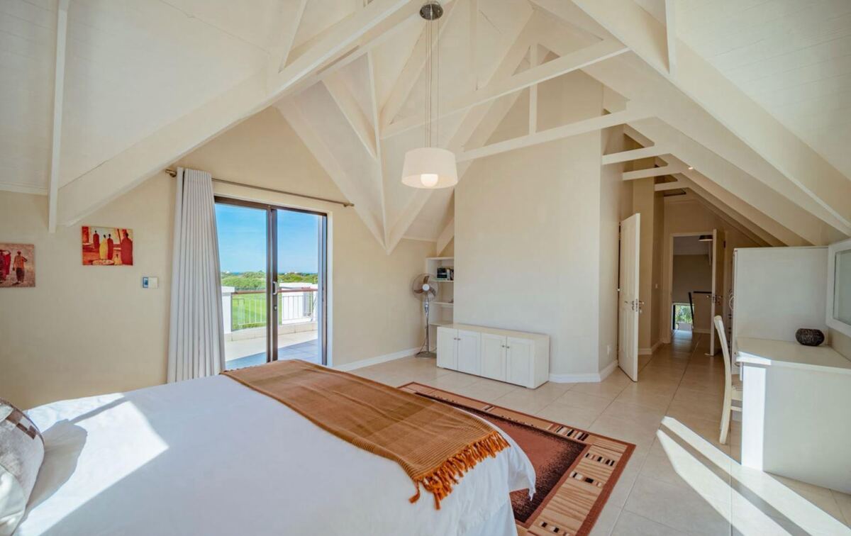 Ground-floor king bedroom opening onto the veranda