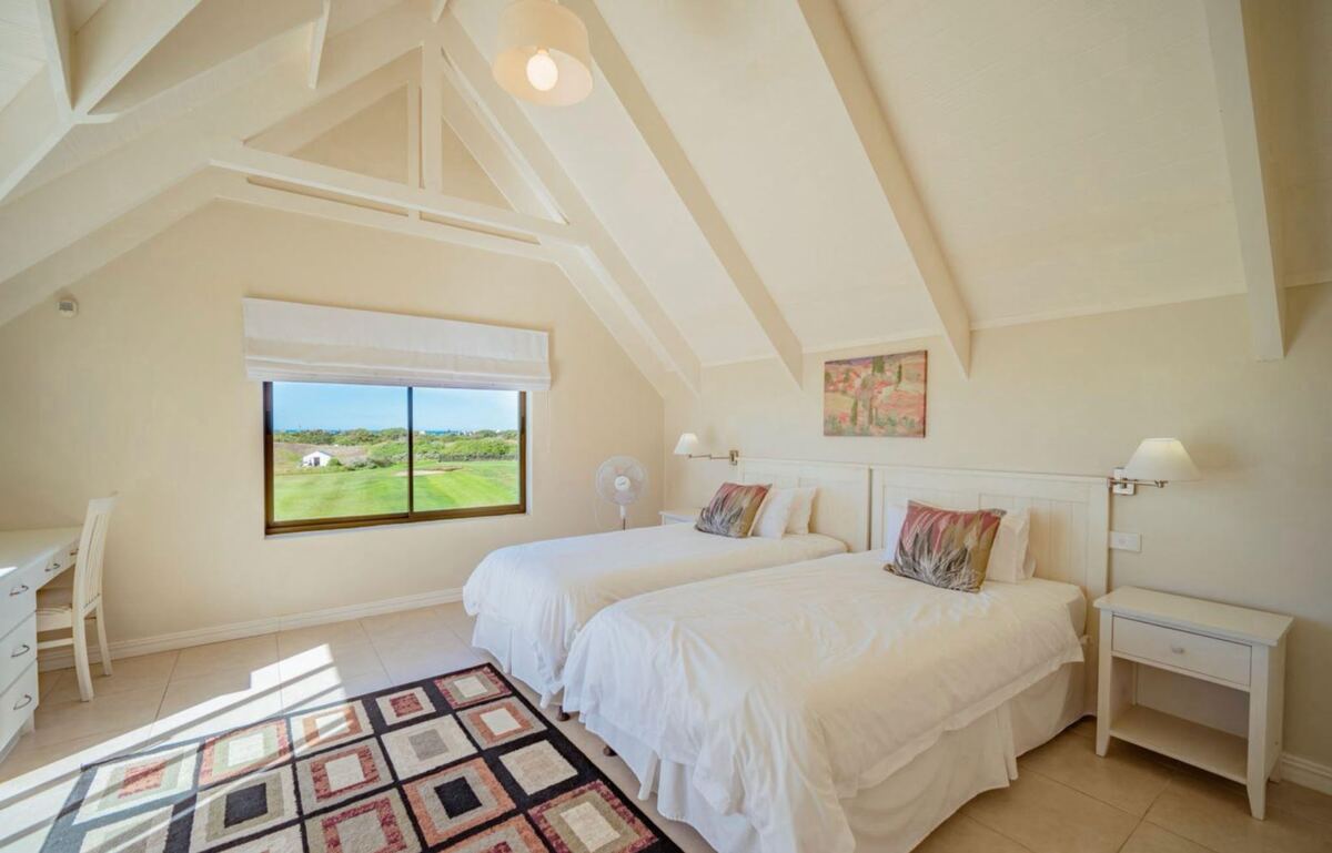 Twin bedroom with a window looking over the fairway