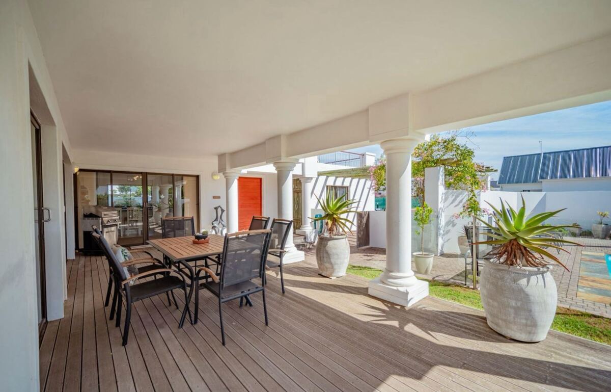 Covered veranda with gas braai, aloes and white columns